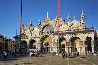 VENICE, ITALY, JUNE 27, 2018: St Mark's Basilica and San Marco square with tourists in Venice,