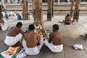 MADURAI, INDIA, FEBRUARY 16, 2013: Indian brahmin (traditional Hindu society) priest and pilgrims