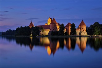 Night view of Trakai Island Castle in lake Galve illuminated in the evening, Lithuania, Europe