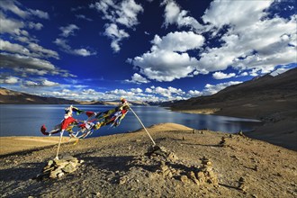 Buddhist prayer flags lungta at Himalayan lake Tso Moriri in Himalayas, Korzok, Ladakh, India, Asia