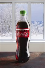 December 7, 2018, Minsk, Belarus, bottle of Coca-Cola on the table with winter view in the window