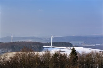 View from the summit of bare trees and wind turbines, sunny winter weather, Köterberg, Lügde,