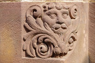 Stylised lion carved in stone on the round arch of a window of the New Town Hall in Rathausgasse,