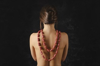 Young woman wearing small piccolini sausages with spices as a beads