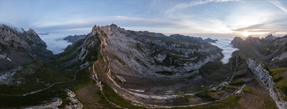 View over Säntis mountains into the valley of Meglisalp at sunrise, high fog in the valley, Säntis,