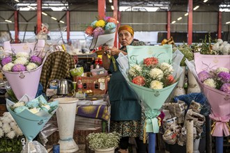 Flower seller at the Osh Bazaar, Bishkek, Kyrgyzstan, Asia