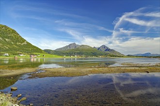 Crystal clear bay with shallow water, green mountain landscape, Leknes, Vestvågøy, Nordland,