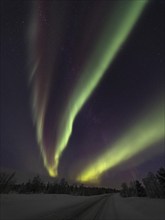 Red and green northern lights over Finnish Lapland