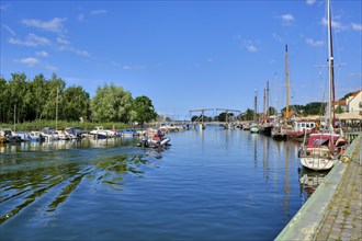 Picturesque view of Greifswald Wieck town harbour with historic wooden bascule bridge over the