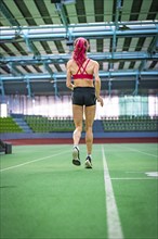 Back view of a sprinter focussing on running fast in the stadium, Glaspalast, Sindelfingen