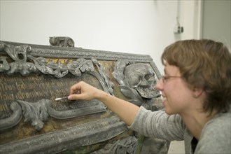 Restorer at Fuchs&Gierke, here a metal sarcophagus from a family vault is expertly cleaned and