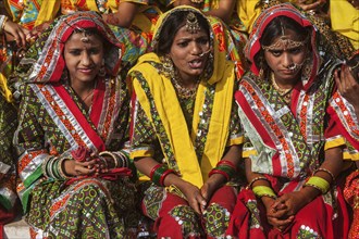 PUSHKAR, INDIA, NOVEMBER 21, 2012: Unidentified Rajasthani girls in traditional outfits prepare for