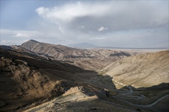 View of mountain landscape and pass road at Tyibel Pass, Song Kul Too mountain range, Naryn region,