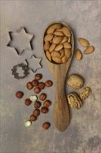 Various nuts with ladle and cookie cutters, baking ingredient