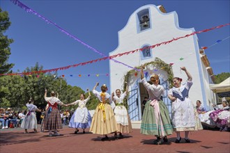 Women in traditional dress dance in front of the Ermita de San Vicent chapel, annual fiesta in