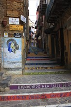 In the old town of Agrigento, Agrigento, colourful staircase in a narrow alley, alleyway art,