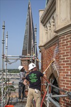 Detroit, Michigan, Kevin Driscoll (right) and Anthony Powell clean and repair the bell towers of