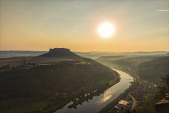 Sunrise at the Lilienstein on Königstein Fortress in Saxon Switzerland The summer heat lies as a