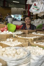 Traditional woman selling food, market stall at Osh Bazaar, Bishkek, Kyrgyzstan, Asia