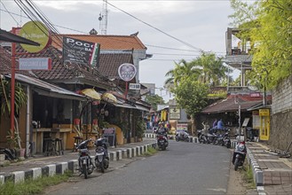 Tourists in bars along street Jalan Bina Ria in the coastal beach town Lovina, Buleleng Regency on