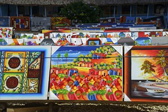 Art stall with paintings depicting tropical landscapes and seascapes, market, Bayahibe, Dominican