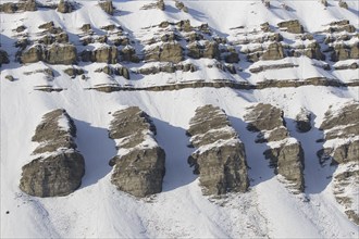 Snow covered Carboniferous mountain slope in autumn, Billefjord, Billefjorden, Svalbard,