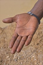 Hand of a diamond hunter displaying a diamond, near Koidu, Koidu-Sefadu, Kono District, Eastern