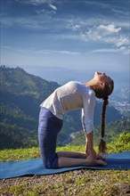 Yoga, outdoors young beautiful slender woman yoga instructor doing camel pose Ustrasana asana