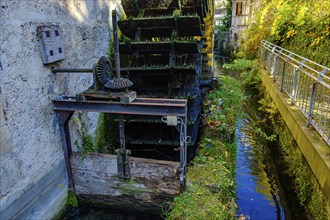 Symbolic image of historical mill wheel and concept of water energy and sustainability, here using