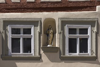 Marian figurine, house saint in a niche between two windows, Zeil am Main, Lower Franconia,