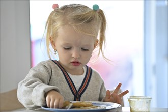 Little girl, 2 years, blonde, eats pancakes, pancake, plate, spoon, eat, Stuttgart,