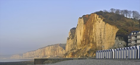 Chalk cliffs and beach cabins on pebble beach at Yport, Upper Normandy, France, Europe