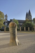 Sculpture The Thumb by César Baldaccini 1993 and UNESCO Basilica St. Kastor in front of the Ludwig