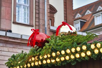 Heidelberg, Germany, November 2019: Huge red and white tree baubles with ribbon on rooftop as part