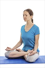 Yoga, young beautiful woman yoga instructor doing Lotus Position (padmasana with chin mudra) asana