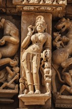 Stone carving bas relief sculpture of woman on Adinath Temple, Khajuraho, Madhya Pradesh, India,