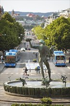 Poseidon statue, hybrid buses at the back in Kungsportsavenyen, Gothenburg, Västra Götalands län,