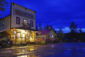 Old wooden hotel from the 1920s and a vintage car in the blue hour, abandoned mining town of