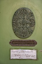 Oval carving and door slot with the inscription Letters & Newspapers as well as sign No free