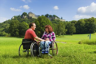 Young couple on the meadows in front of Königstein Fortress