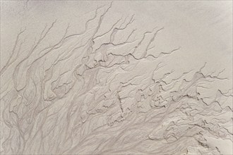 Abstract sand patterns created by retreating water on the beach at low tide, Scotland, United