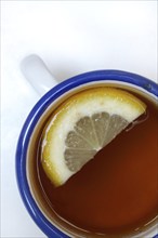 Black tea in cup with lemon slice