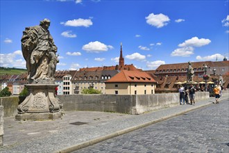 Würzburg, Germany, June 2022: Old Main bridge called ' Alte Mainbrücke' with saint sculpture,