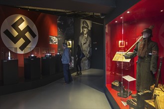 Tourists with audio guides visiting the Bastogne War Museum devoted to the Second World War Two