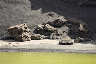 Rock formations along the green lagoon Charco de los Clicos at El Golfo, Lanzarote, Canary Islands,