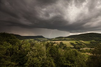 Summer thunderstorm in the Christental valley near Donzdorf, Swabian Alb. Lightning strikes near