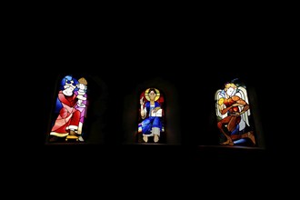 Three colourful church windows with figures in the Ulrich Chapel in the UNESCO Imperial Palace,