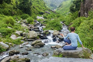 Yoga exercise outdoors, woman doing Ashtanga Vinyasa Yoga asana Marichyasana D seated spinal twist