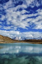 Himalayas mountains refelcting in mountain lake Dhankar Lake. Spiti Valley, Himachal Pradesh,