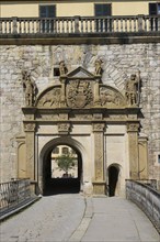 Portal, gate, round arch, bridge, cobblestones, stone figures, coat of arms, relief, decoration,